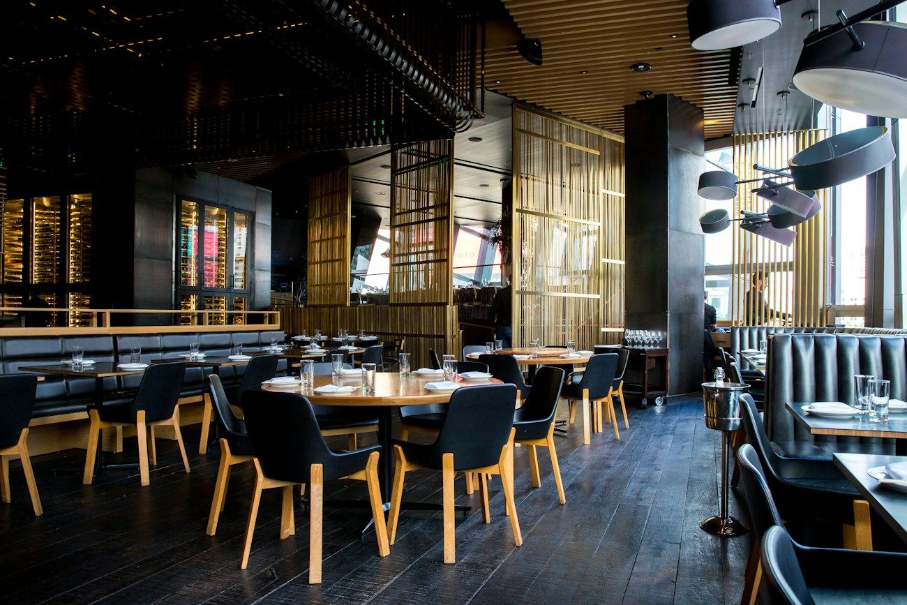 Warm, lively dining room with wood furnishings and soft lights